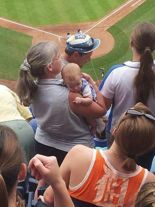 Illustration for article titled Angry Baby Royals Fan Mean-Mugs Tigers Fan, Gives Her The Finger